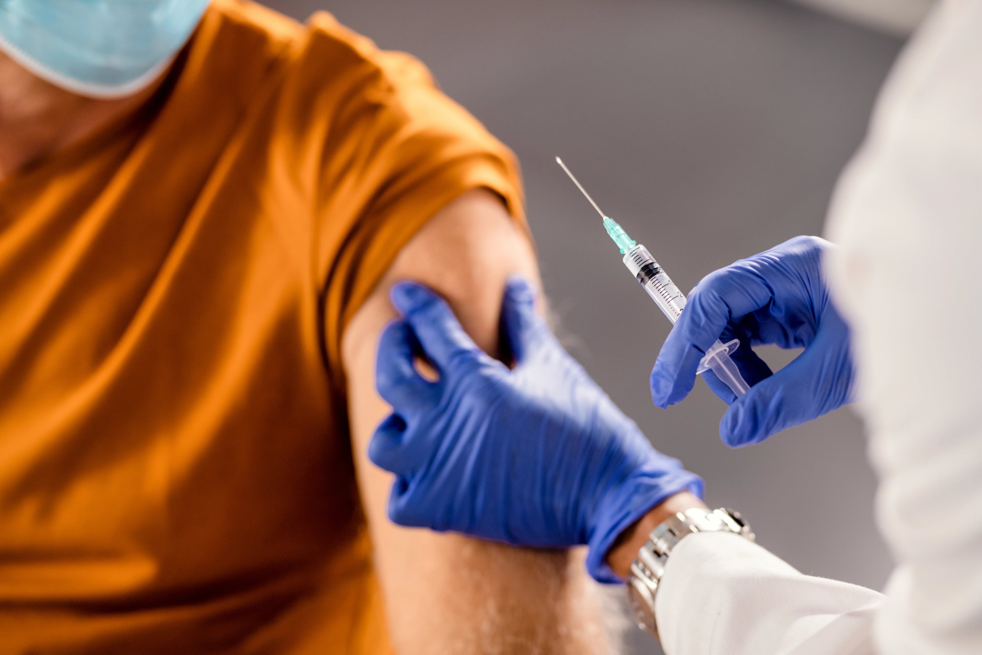 Pharmacist administering a vaccination at Enova Care Pharmacy